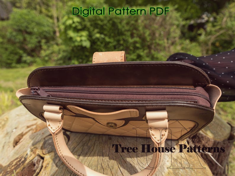 May include: A brown leather handbag with a zippered top and a light brown leather flap. The bag has a quilted design and a metal button closure. The bag is open and the inside is visible. The text "Tree House Patterns" is visible on the bottom of the image.
