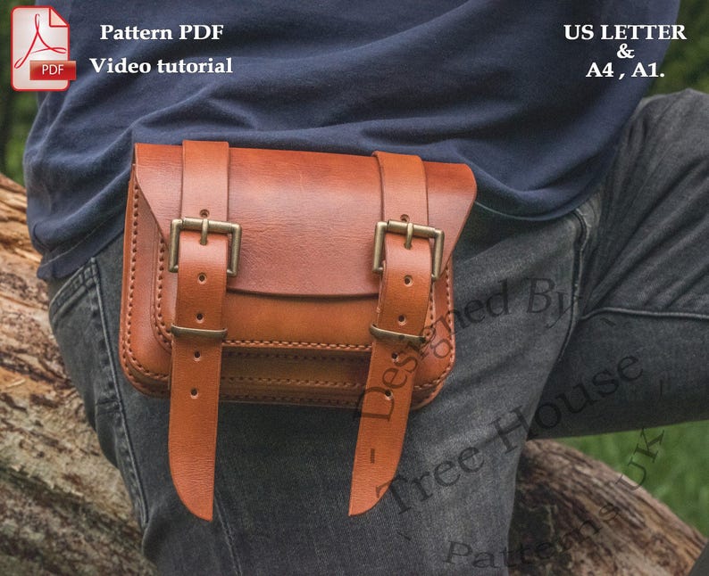 May include: A brown leather belt bag with two buckles. The bag is worn on a person's waist and is secured with a belt. The bag is designed to be worn on the hip and has a flap that closes with a buckle.