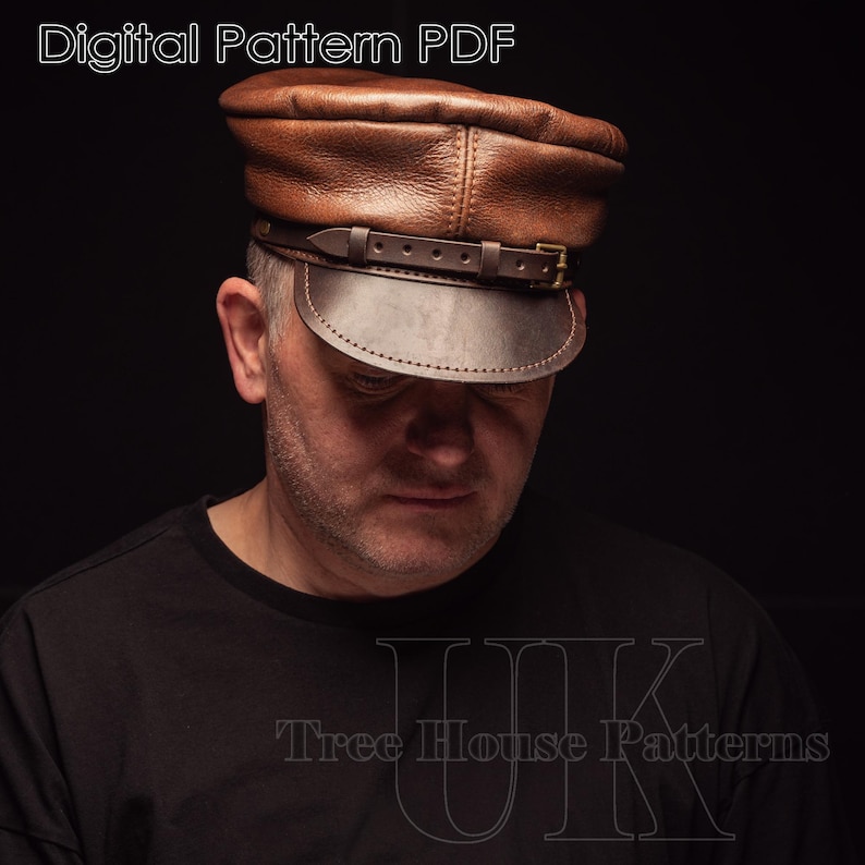 May include: A brown leather cap with a strap and buckle. The cap has a rounded crown and a flat brim. The text "Tree House Patterns" is visible on the bottom of the image.