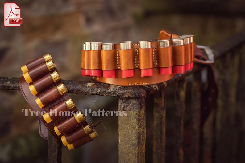 May include: Two leather shotgun shell belts, one brown and one dark brown, with rows of shotgun shells. The belts are displayed on a rusty metal fence. The text 'Tree House Patterns' is visible on the bottom of the image.