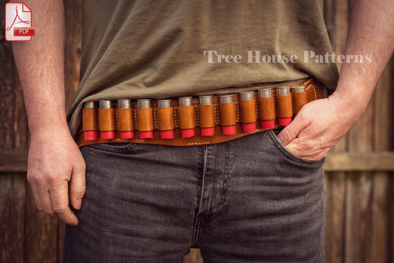 May include: A brown leather shotgun shell belt with 12 shotgun shells. The belt is labeled 'Tree House Patterns'.