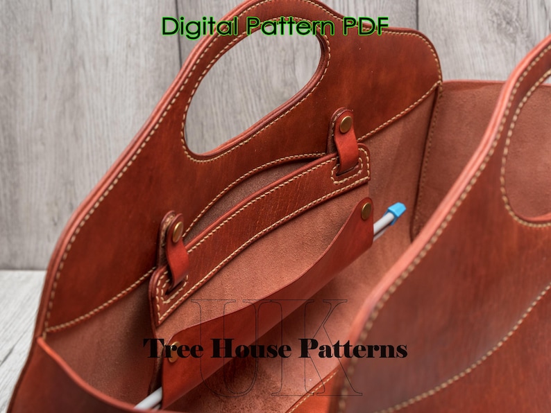 May include: A brown leather tote bag with a top handle and a zipped pocket. The bag is open and the inside is visible. The bag is labelled "Tree House Patterns".