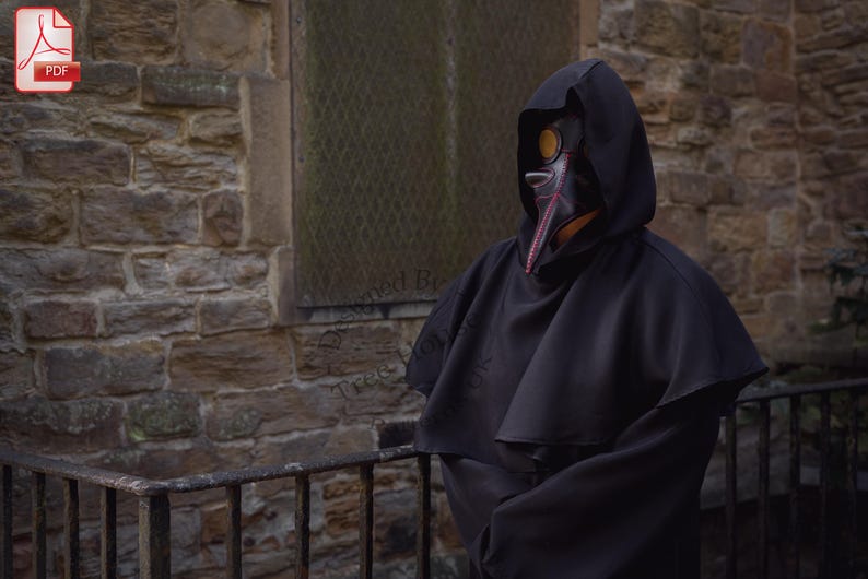 May include: A person wearing a black hooded robe and a plague doctor mask with a long beak. The mask is made of leather and has a red and black design. The person is standing in front of a stone wall.