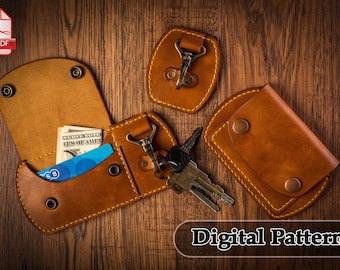 May include: A digital pattern for a leather wallet with a key chain and a separate card holder. The wallet is brown and has a stitched edge. The key chain has a metal hook and a loop for attaching keys. The card holder has a flap with a snap closure.