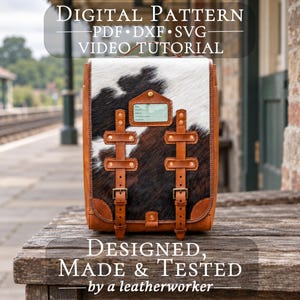 May include: A rectangular backpack featuring a black and white cowhide pattern on the front panel, accented with tan leather trim, two vertical buckled straps, and a small rectangular identification tag. Text reads: DIGITAL PATTERN PDF DXF SVG VIDEO TUTORIAL and DESIGNED, MADE & TESTED by a leatherworker.