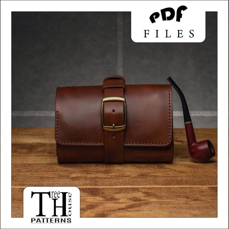 May include: A brown leather tobacco pouch with a brass buckle closure and a brown pipe on a wooden surface. The pouch has a stitched design and the pipe has a brown wooden stem and a black bowl.