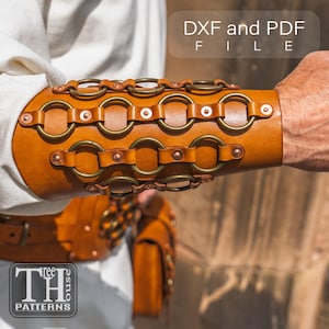 May include: A brown leather bracer with metal rings and rivets. The bracer is designed with multiple rows of circular metal accents and is secured with leather straps. The text "DXF and PDF FILE" is visible in the upper right corner. The logo "TH PATTERNS" is in the lower left corner.