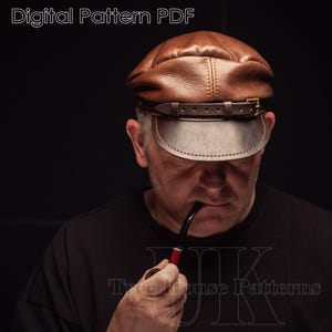 May include: A man wearing a brown leather cap with a brown leather strap and a brass buckle. He is holding a pipe in his mouth and looking down. The text "Treehouse Patterns" is visible in the bottom right corner of the image.