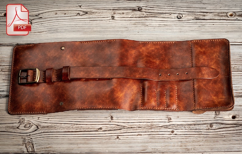 May include: A brown leather wallet with a strap and buckle closure. The wallet has multiple slots for cards and cash.