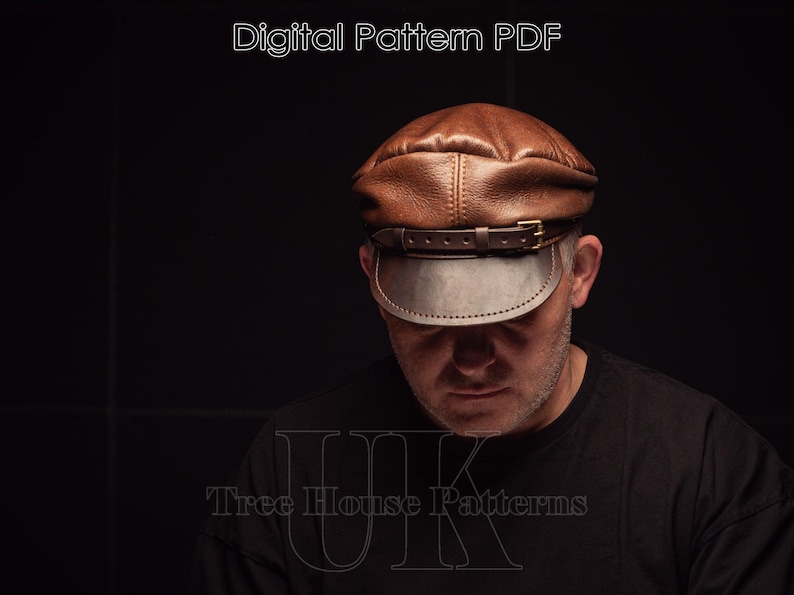 May include: A brown leather cap with a dark brown brim and a strap with a buckle. The cap is worn by a person with a dark shirt. The text "Tree House Patterns" is visible at the bottom of the image.