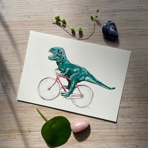 Art Print “Dino on Bicycle” of a hand-painted watercolor illustration by Raissa Oltmanns