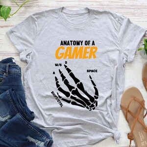 Video Game Lover Shirt
Labeled Skeleton Hands Shirt
Fun Gaming T-Shirt
Gamer Anatomy Shirt
Gaming Apparel
Cool Gamer Graphic Tee
Skeleton Hands Graphic Shirt