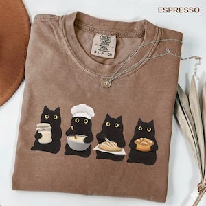May include: A set of three ceramic mugs with a speckled, matte finish. The mugs are in shades of cream, light gray, and dark gray. Each mug has a simple, minimalist design, perfect for coffee or tea.