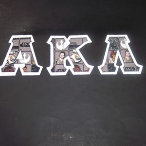 Alpha Kappa Lambda Shirt -- Action Figures on White Twill