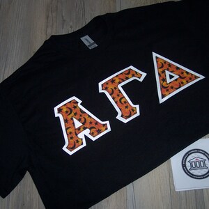 Alpha Gamma Delta Shirt -- Moon & Stars on White Twill (AGD-14)