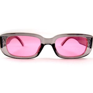 May include: Gray rectangular sunglasses with pink lenses.