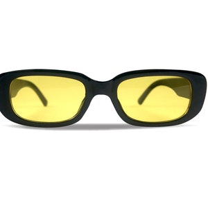 May include: Black rectangular sunglasses with yellow lenses.