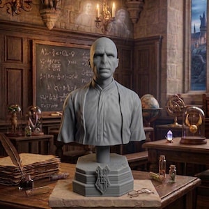 May include: A grey bust of a character from the Harry Potter series, displayed on a stone pedestal. The bust is part of the "Collector's Series" and is set in a detailed, vintage-style room with a chalkboard and candles.