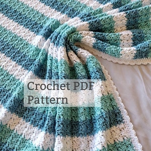 May include: A crochet PDF pattern for a striped blanket in shades of blue and white. The blanket is made with a textured stitch and has a crocheted border.