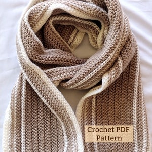May include: A crocheted scarf with brown and white stripes. The scarf is folded in half and the ends are overlapping. The text "Crochet PDF Pattern" is visible on the scarf.