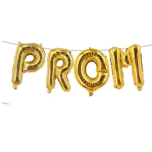 May include: Gold foil balloons spelling out the word "PROM" are strung on a thin, silver string. The balloons are inflated and have a shiny, metallic finish. The letters are large and easy to read, perfect for a prom celebration.