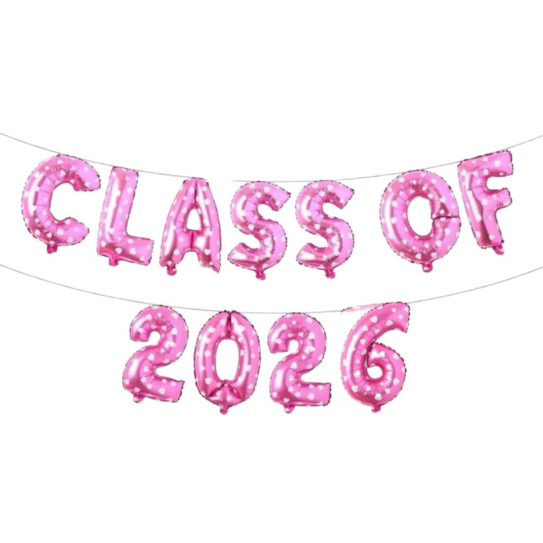 May include: Pink foil balloons spelling out "CLASS OF 2026" with white polka dots. The balloons are strung together on a thin string, perfect for a graduation party or celebration. The letters and numbers are large and easy to read.