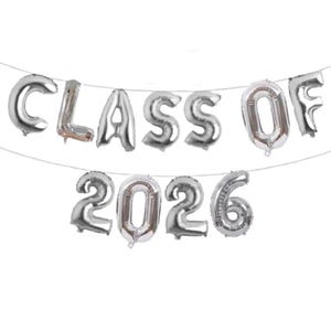 May include: Silver foil balloons spelling out "CLASS OF 2026" strung on a thin white string. The balloons are inflated and have a metallic sheen. Ideal for a graduation celebration.