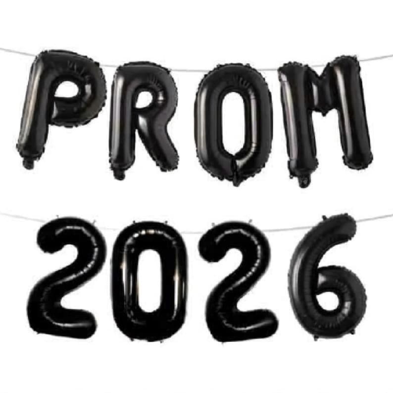 May include: Black foil balloons spelling out "PROM 2026" strung on a thin white string. The balloons are inflated and have a shiny, reflective surface. The letters and numbers are large and easy to read, perfect for a graduation party.