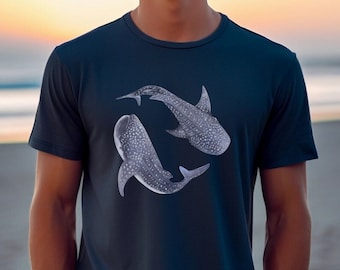 May include: A dark blue t-shirt with a white graphic of two whale sharks swimming.