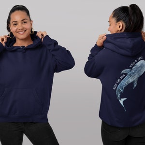 May include: A navy blue hoodie with a white whale shark graphic on the back. The graphic includes the text "Keep the sea wild & free".