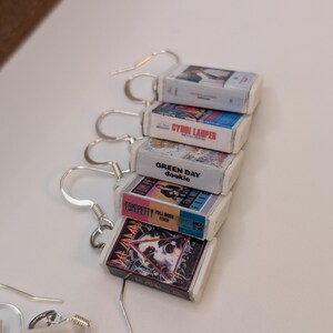 a bunch of cds sitting on top of a white table