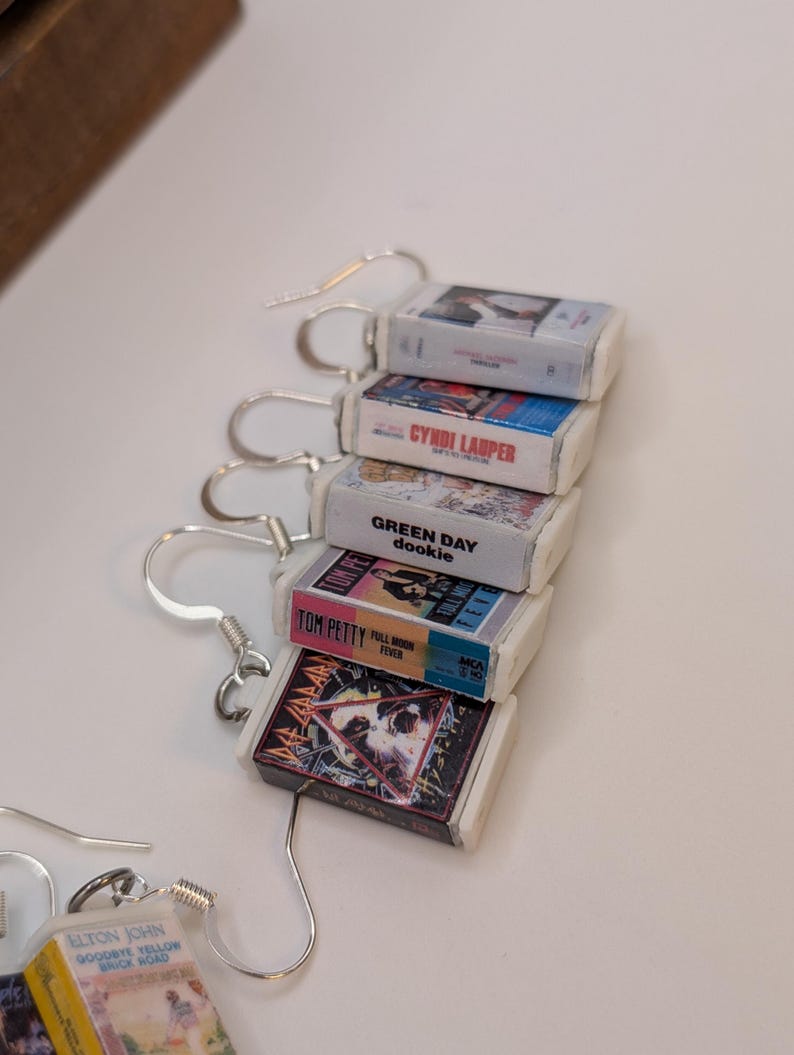 a bunch of cds sitting on top of a white table