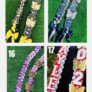 May include: Four graduation leis with names and the year 2025 or 2026. Each lei features a different color scheme, including black and yellow, blue and silver, purple and gold, and red and white. Gold butterfly accents are included.