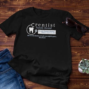 May include: Black t-shirt with a white graphic of a tooth and the text "Crentist Family Dental" with the quote "It's why I became a dentist! -Robert Crentist, 000" and the text "We're a new dentist, we're far, you might be gone... three hours".