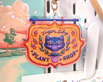 Derpy Tiger – bord met plantenwinkel – iriserende acrylsleutelhanger | K-Pop-filmpersonage