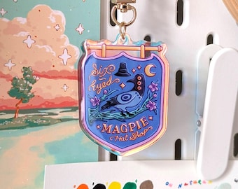 Sussy Bird – uithangbord hoedenwinkel – iriserende acrylsleutelhanger | K-Pop-filmpersonage