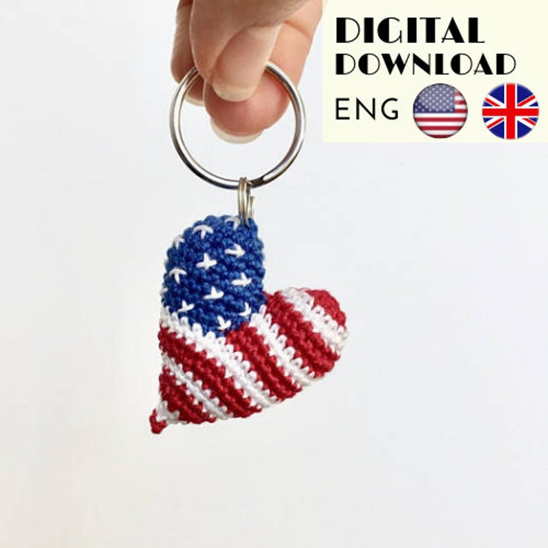 May include: A crocheted heart-shaped keychain with the American flag design. The keychain is attached to a silver key ring.