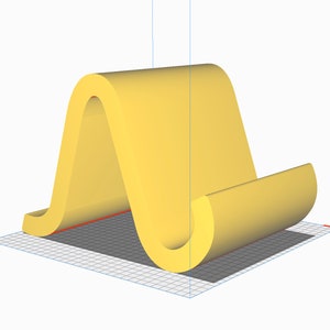 Könnte beinhalten: Ein gelber Telefonständer aus Kunststoff. Der Ständer ist wellenförmig und hat ein geschwungenes Design.