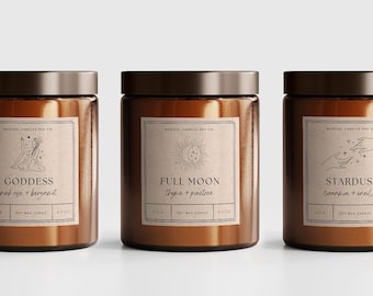May include: Three amber glass candle jars with brown lids and paper labels. The labels feature illustrations of a goddess, a full moon, and hands reaching for stars. The candle scents are listed as Goddess: pink rose & bergamot, Full Moon: sage & pine tree, and Stardust: cinnamon & vanilla.