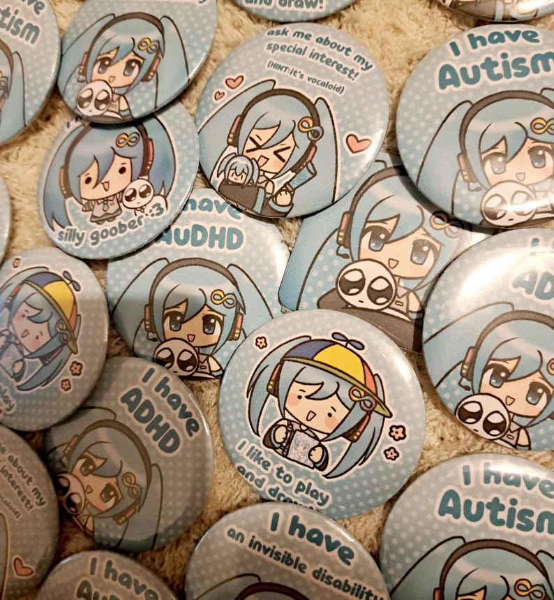 May include: A collection of light blue pinback buttons featuring anime-style illustrations. The buttons display various phrases, including "I have Autism," "I have ADHD," and "ask me about my special interest!" The illustrations include a character with blue hair and headphones.
