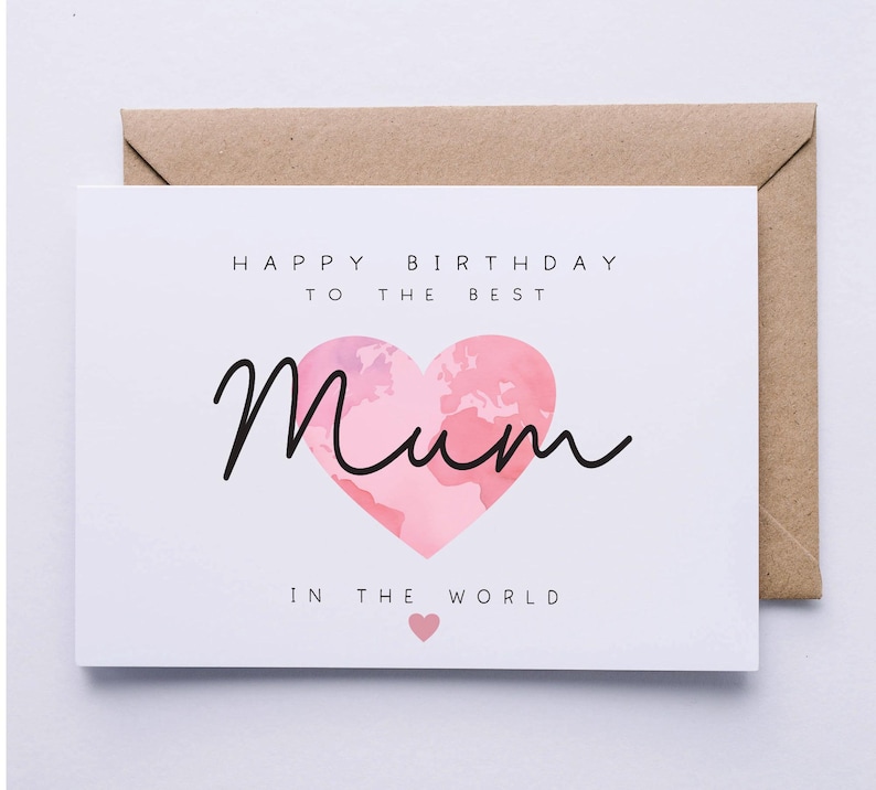 May include: A white card with the text "Happy Birthday to the Best Mum in the World" with a pink heart with a world map design.