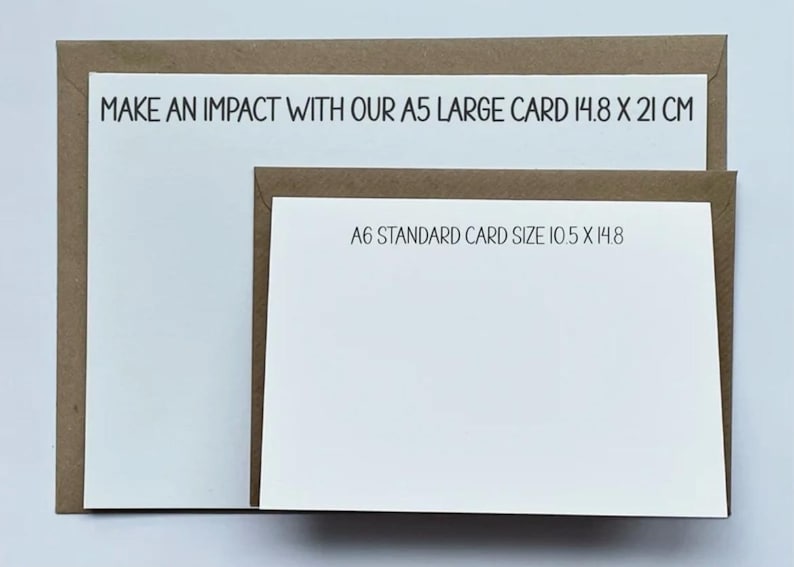 May include: Two white cards with brown borders. The larger card has the text "MAKE AN IMPACT WITH OUR A5 LARGE CARD 14.8 X 21 CM". The smaller card has the text "A6 STANDARD CARD SIZE 10.5 X 14.8".