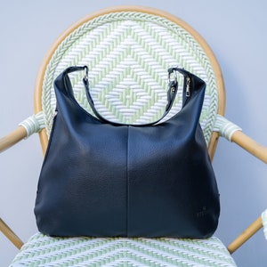 Shoulder bag shop with outside pockets