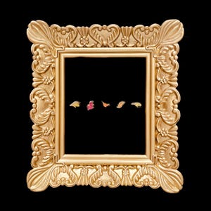 May include: A rectangular gold-colored frame with ornate, embossed floral and scrollwork detailing. Inside the frame, five small, distinct enamel pins are arranged in a horizontal row, featuring various leaf and abstract shapes in colors.