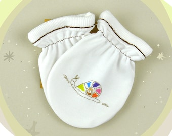 May include: A pair of white baby mittens with brown trim. The mittens have a colorful snail design on one of them.