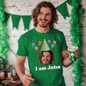 a man wearing a green t - shirt with a picture of a man's