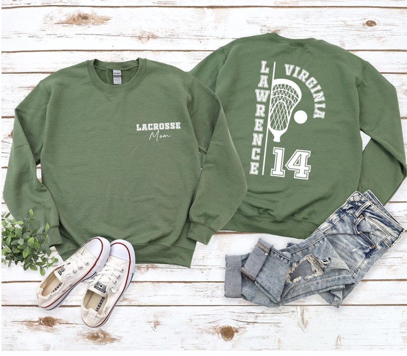 a pair of green sweatshirts sitting on top of a wooden floor
