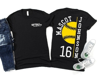 May include: Black t-shirts with softball designs. One shirt has "SOFTBALL mom" in white script. The other shows a yellow softball with "MASCOT JOHNSON 16" in white lettering. A pair of grey trainers and blue jeans are also in the image.