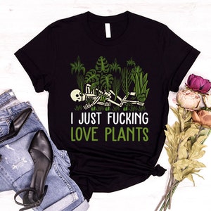 May include: Black t-shirt with a skeleton surrounded by plants and the text "I just fucking love plants".
