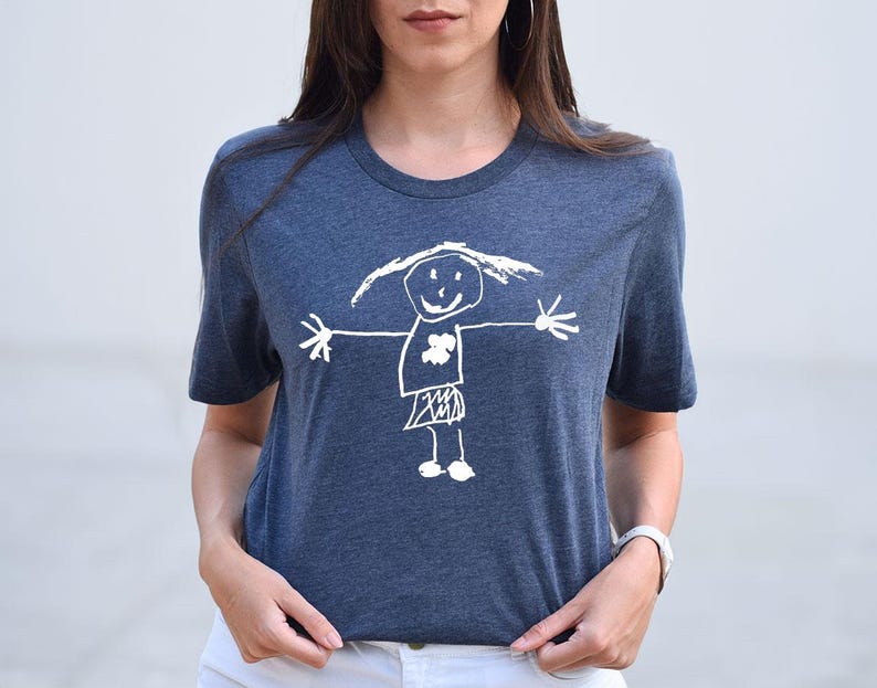 a woman wearing a t - shirt with a drawing of a girl holding an umbrella
